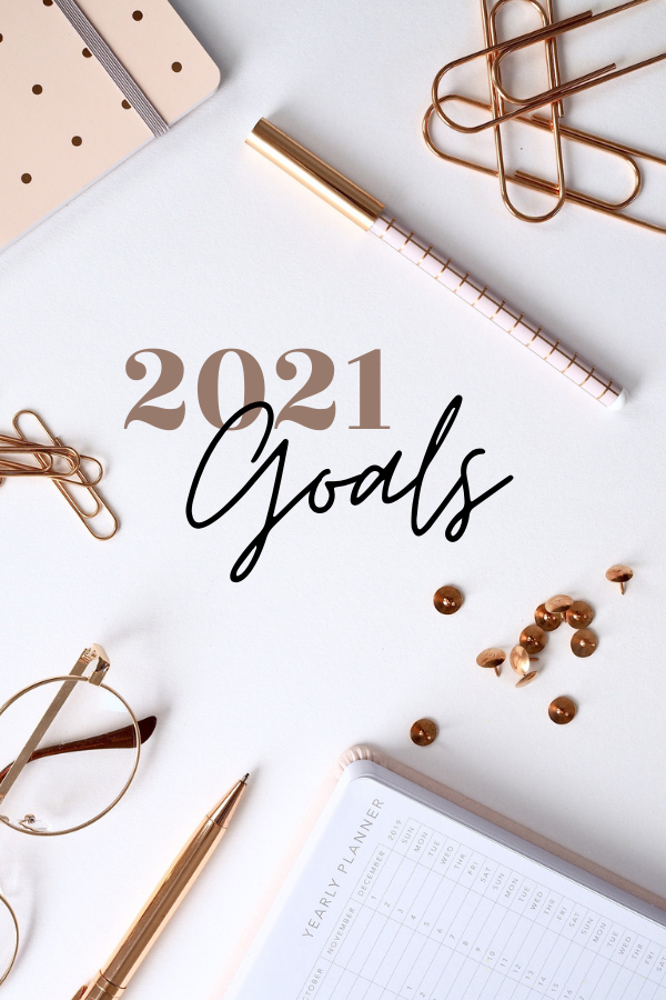 desk with planner, paper clips, glasses