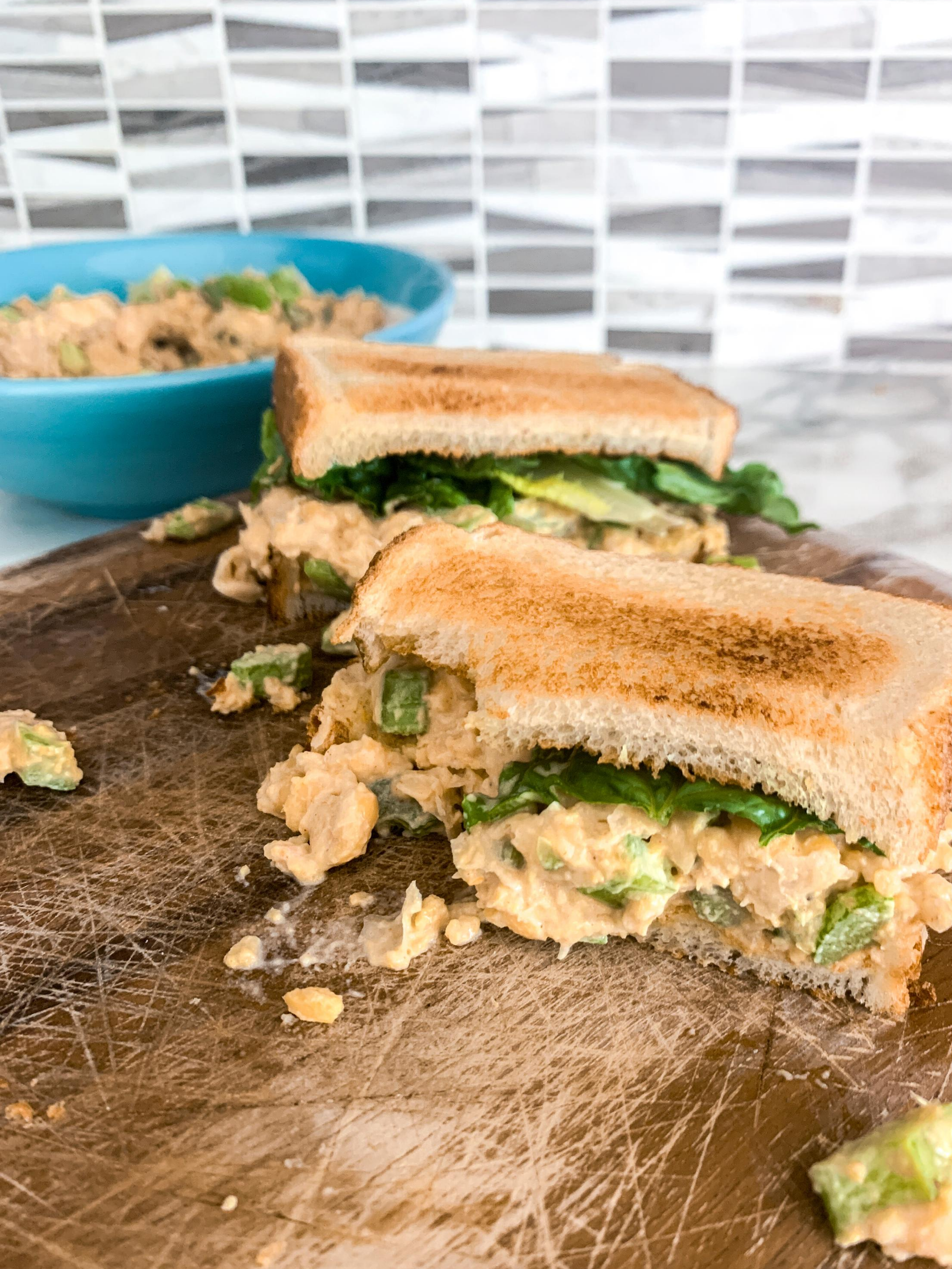 chickpea salad sandwich on cutting board
